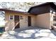 Rear view of house showing tan brick exterior, brown door and windows at 73 N Carol Ave, Mascotte, FL 34753