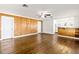 Living area with hardwood floors and wood accent wall at 73 N Carol Ave, Mascotte, FL 34753