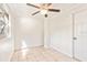 Bright spare bedroom with tile floors and ceiling fan at 73 N Carol Ave, Mascotte, FL 34753