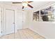 Well-lit spare bedroom with tile floors and double closets at 73 N Carol Ave, Mascotte, FL 34753