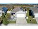 One-story house with solar panels, driveway, and landscaped yard, viewed from above at 808 Brooklet Dr, Davenport, FL 33837