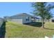 Spacious backyard with covered patio and grassy area at 808 Brooklet Dr, Davenport, FL 33837