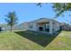 Large backyard with covered patio and play area at 808 Brooklet Dr, Davenport, FL 33837