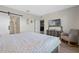 Main bedroom with king bed, rocking chair, and barn door at 808 Brooklet Dr, Davenport, FL 33837