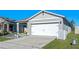 Gray house with white garage door, landscaping, and a walkway leading to the entrance at 808 Brooklet Dr, Davenport, FL 33837