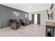 Relaxing living room with gray recliner chairs and wood floors at 808 Brooklet Dr, Davenport, FL 33837