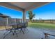 Covered patio with table and chairs, overlooking yard at 808 Brooklet Dr, Davenport, FL 33837