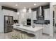 Modern kitchen with white cabinets, stainless steel appliances, and an island at 8675 Bridgeport Bay Cir, Mount Dora, FL 32757