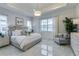 Bright main bedroom with large windows and en-suite bathroom at 8675 Bridgeport Bay Cir, Mount Dora, FL 32757