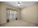 Bedroom with window, ceiling fan and neutral carpeting at 9565 Se 124Th Loop, Summerfield, FL 34491