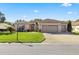 Single-story home with attached garage and manicured lawn at 9565 Se 124Th Loop, Summerfield, FL 34491