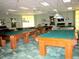 Bright community game room with multiple billiard tables for residents' entertainment at 9565 Se 124Th Loop, Summerfield, FL 34491