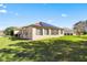 House exterior with solar panels and landscaped yard at 9565 Se 124Th Loop, Summerfield, FL 34491