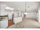 Kitchen with island, granite countertops, and white cabinets at 9565 Se 124Th Loop, Summerfield, FL 34491