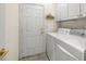 Laundry room with washer, dryer, and built-in cabinets at 9565 Se 124Th Loop, Summerfield, FL 34491