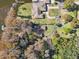 Aerial view of two houses on a large lot with mature trees and a waterfront view at 9724 Rosemary Ln, Leesburg, FL 34788