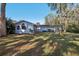 Back view of house with large windows and yard at 9724 Rosemary Ln, Leesburg, FL 34788