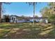 Back of house showcasing large windows and backyard at 9724 Rosemary Ln, Leesburg, FL 34788