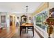 Bright dining area with hardwood floors and view to backyard at 9724 Rosemary Ln, Leesburg, FL 34788