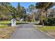 Long driveway leading to a home with a detached shed at 9724 Rosemary Ln, Leesburg, FL 34788