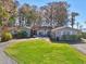 Light blue house exterior with a circular driveway and manicured lawn at 9724 Rosemary Ln, Leesburg, FL 34788