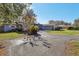 Light blue house with a circular driveway and manicured lawn at 9724 Rosemary Ln, Leesburg, FL 34788