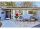 Welcoming front entry with a stone accent and patio seating area at 9724 Rosemary Ln, Leesburg, FL 34788