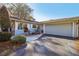 Home exterior featuring a two-car garage and inviting entryway at 9724 Rosemary Ln, Leesburg, FL 34788