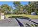 Landscaped front yard with a shed and long driveway at 9724 Rosemary Ln, Leesburg, FL 34788