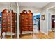 Spacious hallway with mirrored closets and antique furniture at 9724 Rosemary Ln, Leesburg, FL 34788