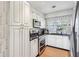 Modern kitchen with stainless steel appliances and white cabinets at 9724 Rosemary Ln, Leesburg, FL 34788