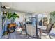 Relaxing screened porch with table and chairs, perfect for outdoor dining at 9724 Rosemary Ln, Leesburg, FL 34788