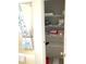 Bright storage in the bathroom with shelves full of linens and toiletries at 10173 Se 175Th Ln, Summerfield, FL 34491