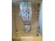 Tiled tub and shower combo features a white showerhead and charming shower curtain at 10173 Se 175Th Ln, Summerfield, FL 34491