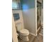 Updated bathroom features white wainscoting, toilet, and glass enclosed shower at 10173 Se 175Th Ln, Summerfield, FL 34491