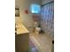 Standard bathroom with single vanity, toilet, tub with shower curtain, and neutral tones at 10173 Se 175Th Ln, Summerfield, FL 34491
