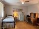Bedroom featuring comfortable bed, side table, desk, and well-lit workspace at 10173 Se 175Th Ln, Summerfield, FL 34491