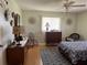 Relaxing bedroom with a bed, a nightstand, a dresser, a ceiling fan, and two windows at 10173 Se 175Th Ln, Summerfield, FL 34491