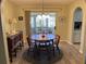 Bright dining room with wood table and chairs, and access to enclosed patio at 10173 Se 175Th Ln, Summerfield, FL 34491