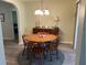 Cozy dining area features a round wooden table, four chairs, and a woodgrain floor at 10173 Se 175Th Ln, Summerfield, FL 34491