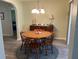 Dining room features a round wooden table with four chairs and a buffet at 10173 Se 175Th Ln, Summerfield, FL 34491