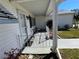 Relax on this cozy covered front porch, with seating and peaceful neighborhood views at 10173 Se 175Th Ln, Summerfield, FL 34491