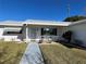 Cozy covered front porch with seating and charming landscaping welcomes you home at 10173 Se 175Th Ln, Summerfield, FL 34491