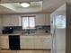 Functional kitchen with white cabinets, laminate counters, tile backsplash, and modern appliances at 10173 Se 175Th Ln, Summerfield, FL 34491