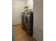 Laundry room showcasing modern washer and dryer units and door to hallway at 10173 Se 175Th Ln, Summerfield, FL 34491