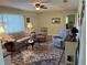 Living room with light beige walls, comfy seating, and patterned rug at 10173 Se 175Th Ln, Summerfield, FL 34491