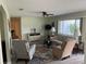 Inviting living room with a ceiling fan, neutral walls, area rug, and comfortable seating with natural light at 10173 Se 175Th Ln, Summerfield, FL 34491