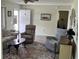 Bright living room with comfortable seating, a decorative rug, and natural light streaming through the nearby window at 10173 Se 175Th Ln, Summerfield, FL 34491