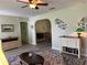 Inviting living room featuring a ceiling fan, unique decor, and an archway leading to another room at 10173 Se 175Th Ln, Summerfield, FL 34491