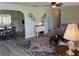 Comfortable living room showcases a large rug and open access to the dining area and modern kitchen at 10173 Se 175Th Ln, Summerfield, FL 34491